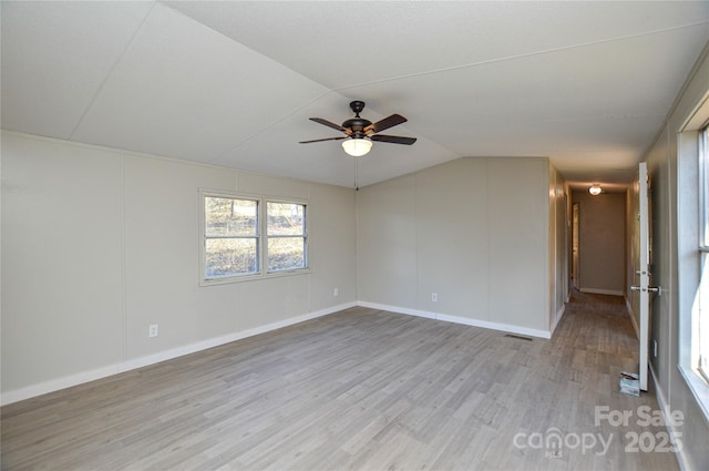 unfurnished room featuring ceiling fan, lofted ceiling, and light hardwood / wood-style floors