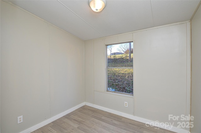 unfurnished room with light hardwood / wood-style flooring