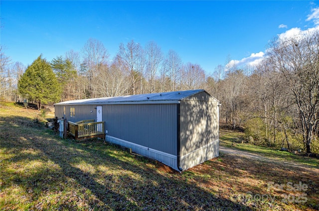 view of outbuilding featuring a yard