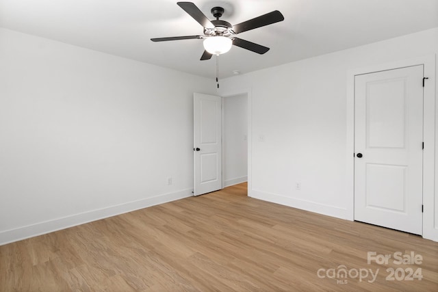 empty room featuring ceiling fan and light hardwood / wood-style flooring