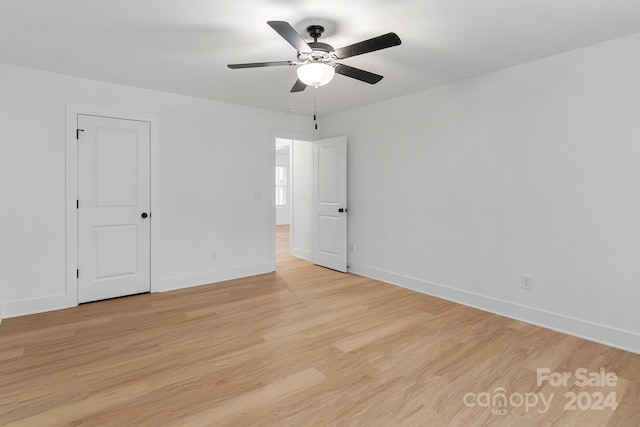 empty room featuring light wood-type flooring and ceiling fan