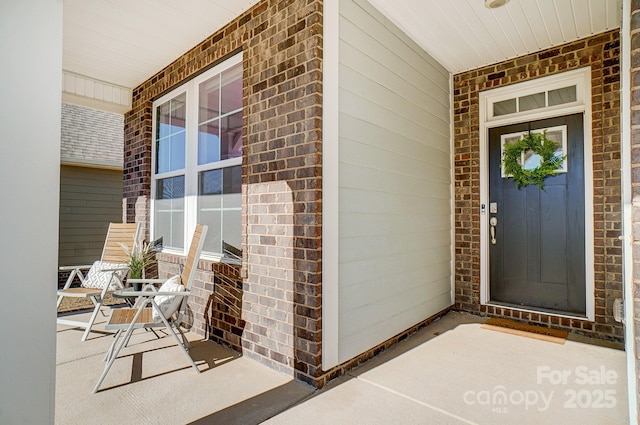 view of exterior entry featuring a porch