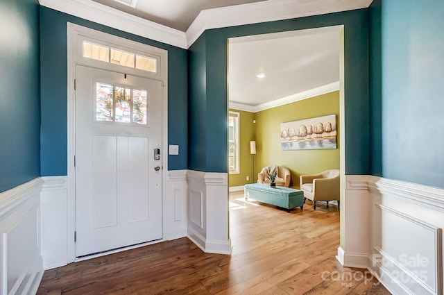 foyer entrance featuring hardwood / wood-style flooring and crown molding