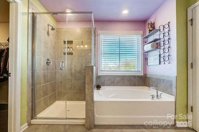 bathroom with tile patterned floors and independent shower and bath