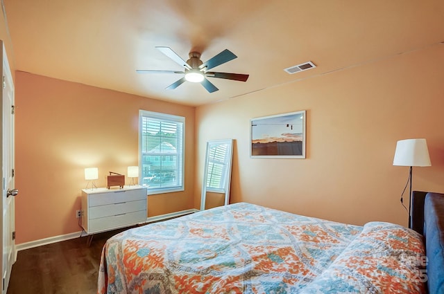 bedroom with ceiling fan and dark wood-type flooring