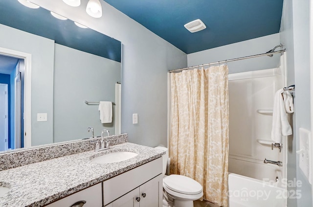 full bathroom featuring vanity, toilet, and shower / tub combo