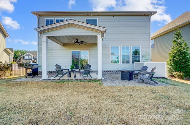 back of property featuring a yard, ceiling fan, and a patio area