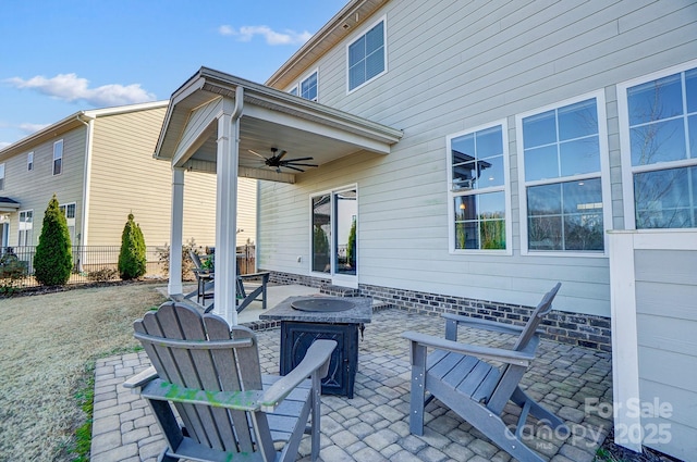 view of patio featuring an outdoor fire pit and ceiling fan