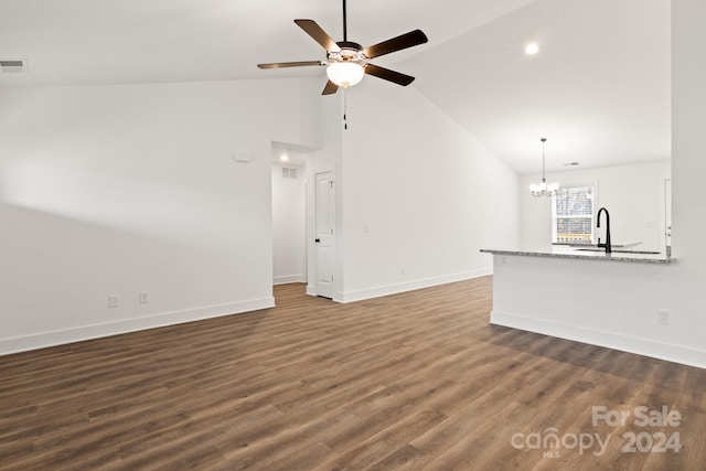 unfurnished living room featuring ceiling fan with notable chandelier, dark hardwood / wood-style flooring, high vaulted ceiling, and sink