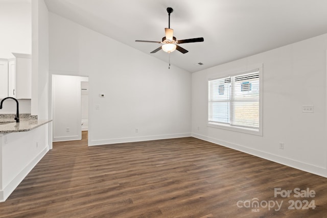 unfurnished living room featuring dark hardwood / wood-style flooring, ceiling fan, sink, and lofted ceiling