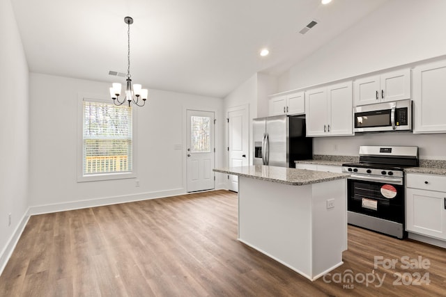 kitchen featuring white cabinets, an inviting chandelier, stainless steel appliances, and a kitchen island