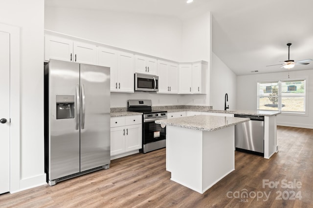 kitchen featuring kitchen peninsula, white cabinetry, sink, and stainless steel appliances