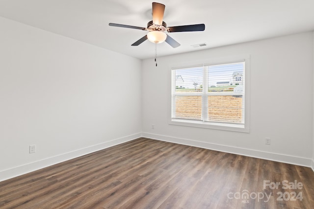 spare room featuring ceiling fan and dark hardwood / wood-style floors