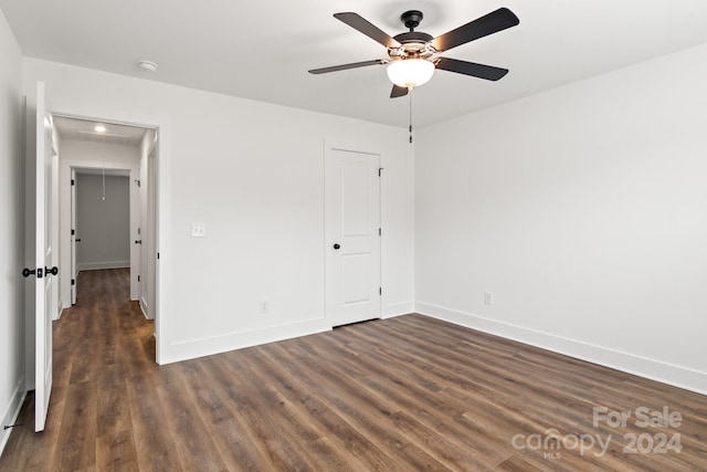 unfurnished bedroom featuring ceiling fan, dark hardwood / wood-style flooring, and a closet