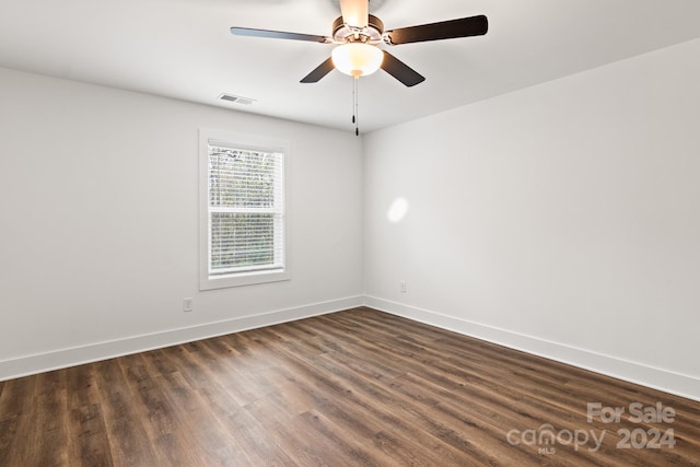 unfurnished room with ceiling fan and dark hardwood / wood-style flooring