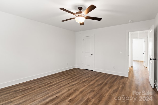 unfurnished bedroom featuring a closet, ceiling fan, and dark hardwood / wood-style flooring