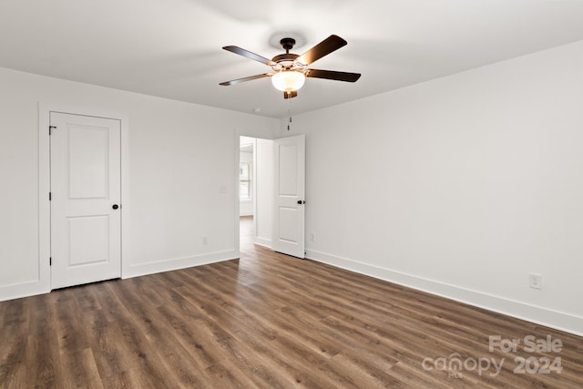 unfurnished bedroom featuring ceiling fan and dark wood-type flooring