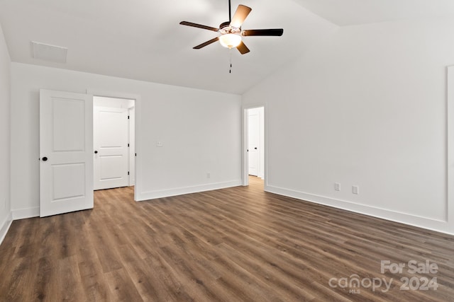 empty room featuring ceiling fan, high vaulted ceiling, and dark wood-type flooring