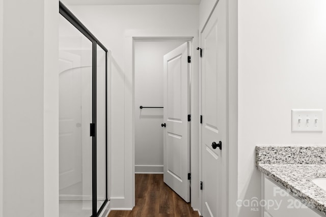 corridor with dark hardwood / wood-style flooring