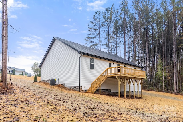 back of house featuring a wooden deck and cooling unit