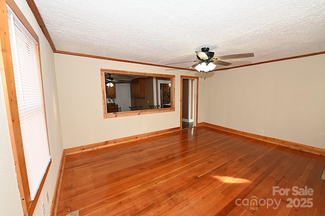 interior space with wood-type flooring, a textured ceiling, and ornamental molding