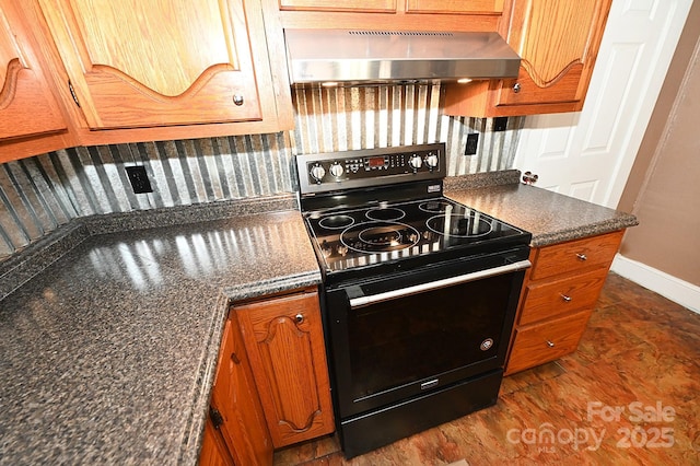 kitchen featuring wall chimney range hood and black / electric stove