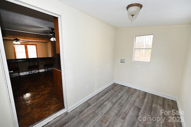 empty room featuring a textured ceiling and dark hardwood / wood-style floors