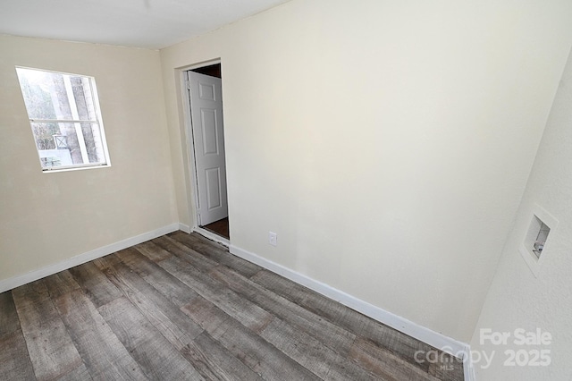 spare room featuring dark wood-type flooring