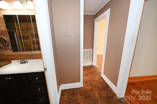 bathroom with vanity and crown molding