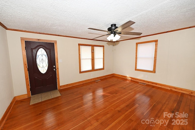 foyer with a textured ceiling, hardwood / wood-style flooring, and ceiling fan