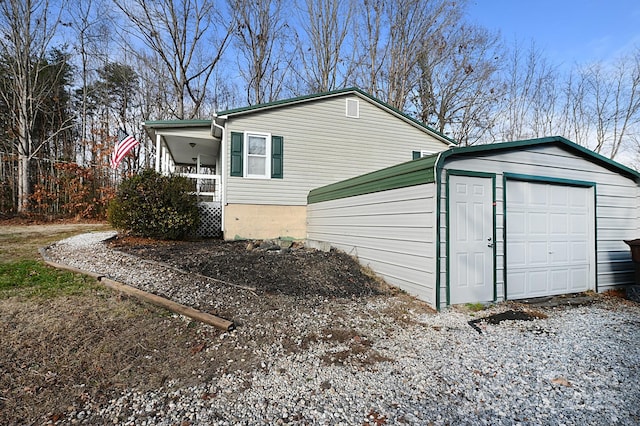 view of side of property featuring an outbuilding and a garage