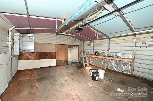 garage with an AC wall unit and a garage door opener