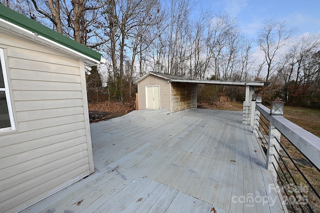 wooden deck featuring an outbuilding