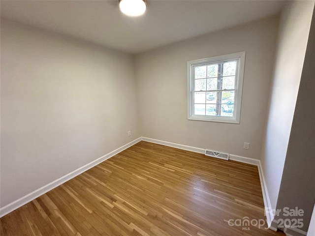 empty room with wood-type flooring