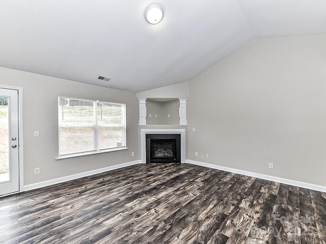 unfurnished living room featuring dark hardwood / wood-style flooring and vaulted ceiling