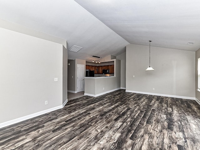 unfurnished living room with dark hardwood / wood-style floors and vaulted ceiling