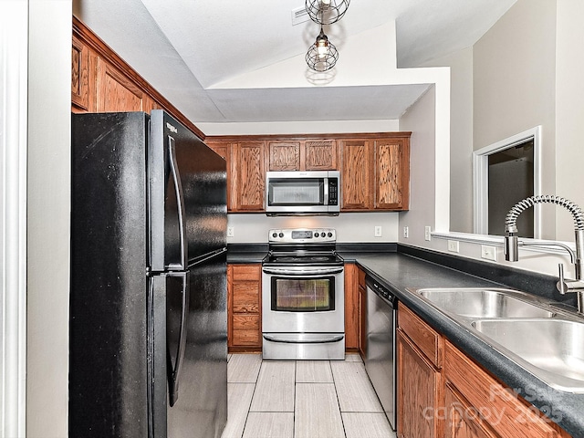 kitchen with lofted ceiling, sink, and appliances with stainless steel finishes