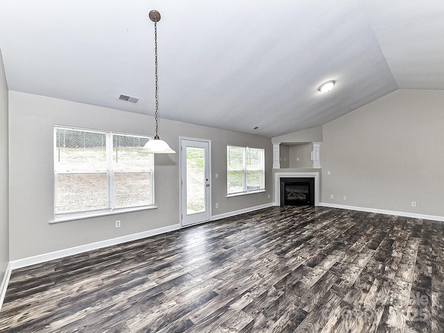 unfurnished living room with dark wood-type flooring and vaulted ceiling