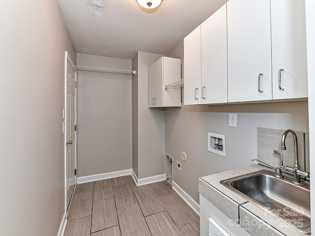 laundry room featuring electric dryer hookup, cabinets, hookup for a gas dryer, sink, and washer hookup