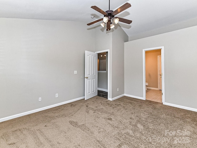 unfurnished bedroom with ceiling fan, carpet floors, high vaulted ceiling, and ensuite bath