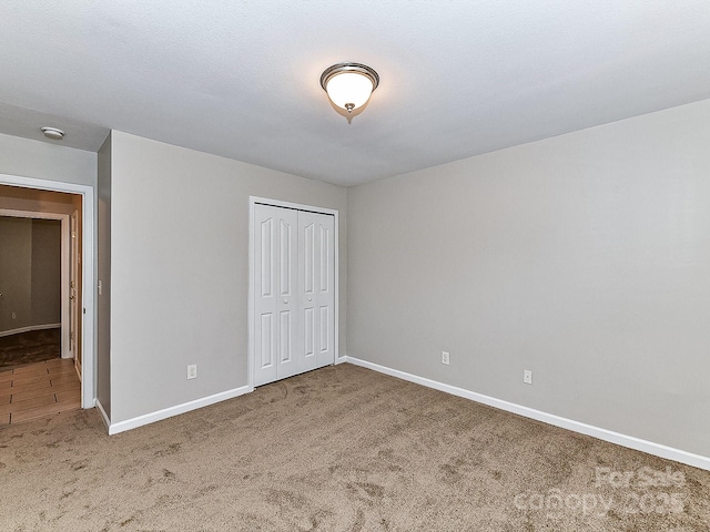 unfurnished bedroom with carpet floors and a closet