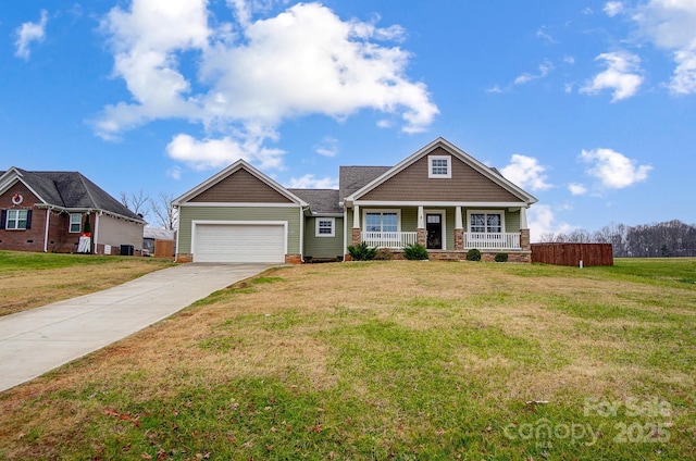 craftsman inspired home with a front yard, a porch, and a garage