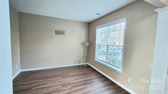 empty room with dark wood-type flooring