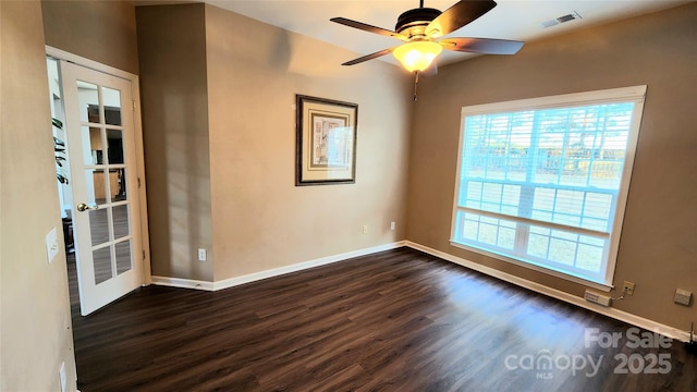 unfurnished room with ceiling fan and dark wood-type flooring