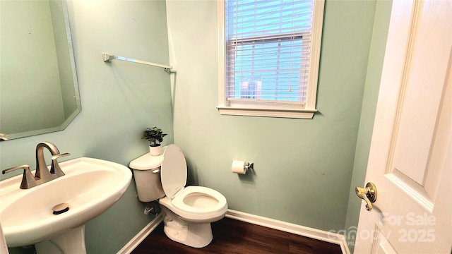 bathroom featuring hardwood / wood-style floors, toilet, a wealth of natural light, and sink