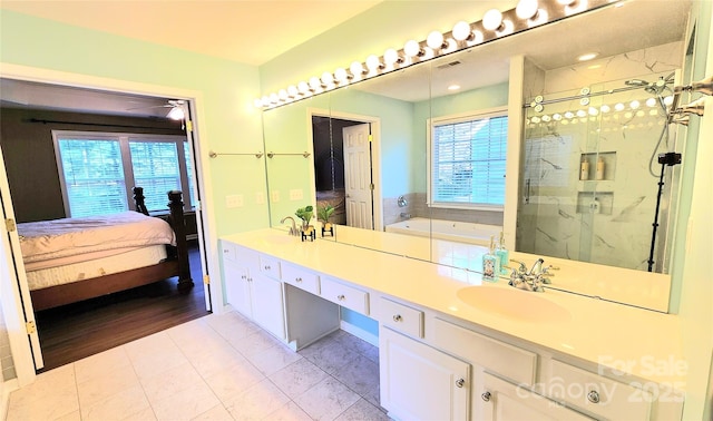 bathroom featuring tile patterned floors, vanity, and separate shower and tub