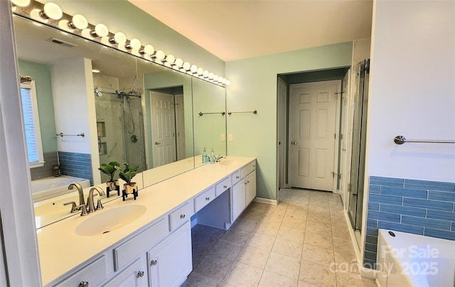 bathroom with tile patterned flooring, vanity, and independent shower and bath