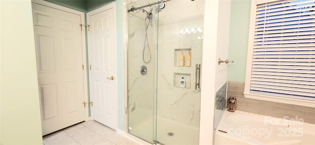 bathroom with tile patterned flooring and separate shower and tub