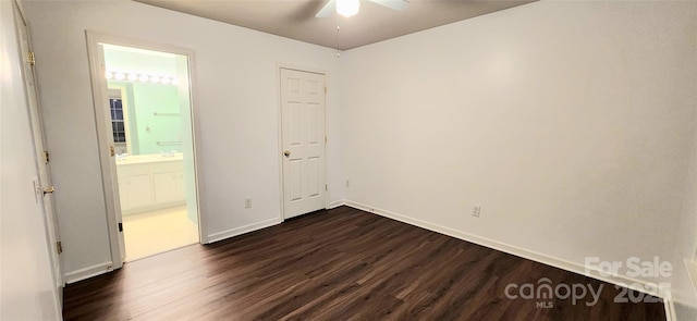 unfurnished bedroom featuring ensuite bathroom, ceiling fan, and dark hardwood / wood-style floors