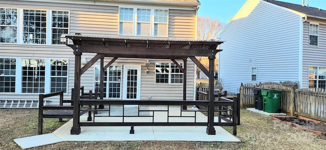 back of property featuring a pergola